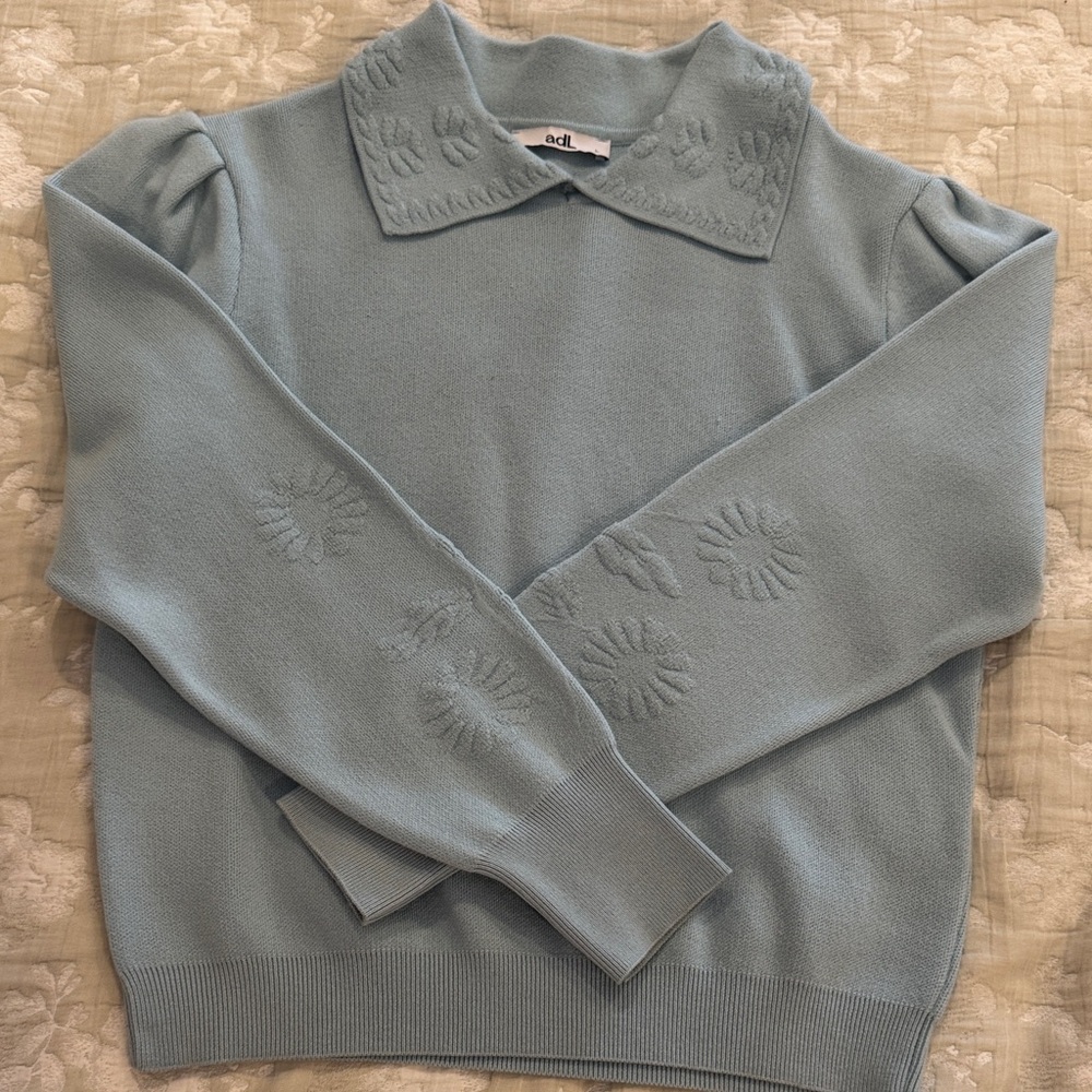 Elegant Light Blue Sweater with Floral Accents